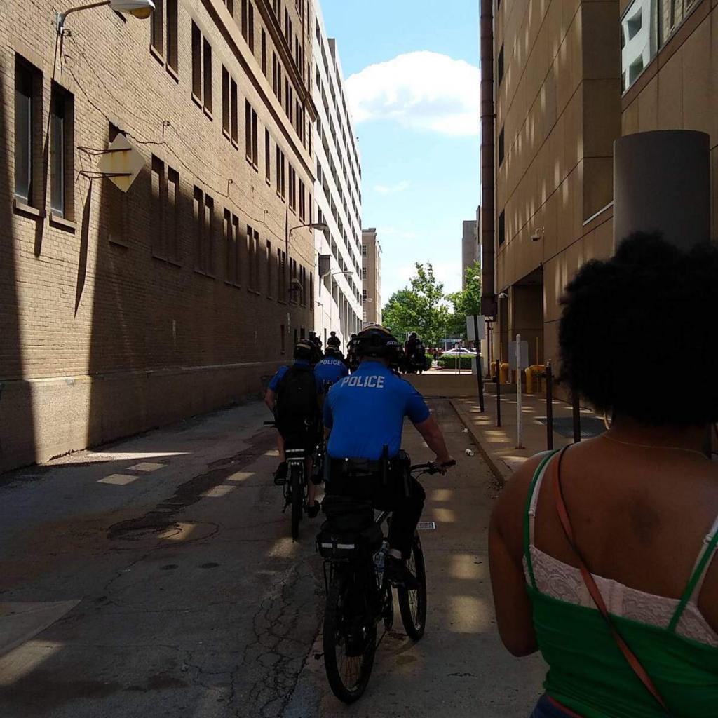 Mounted police and bicycle police blocking an alley leading away from Courthouse Square.